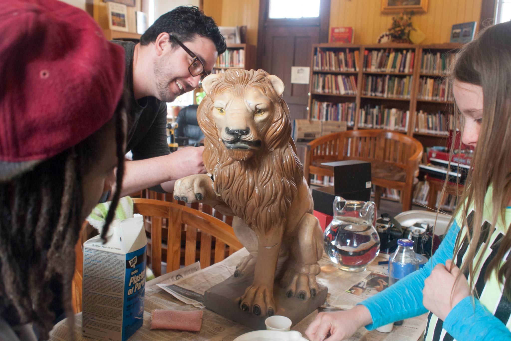 Repairing a lion statue at Magdalena's FIXIT Friday event.