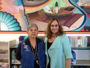 Jeannie Whitehorse & Alana McGrattan in front of a mural.