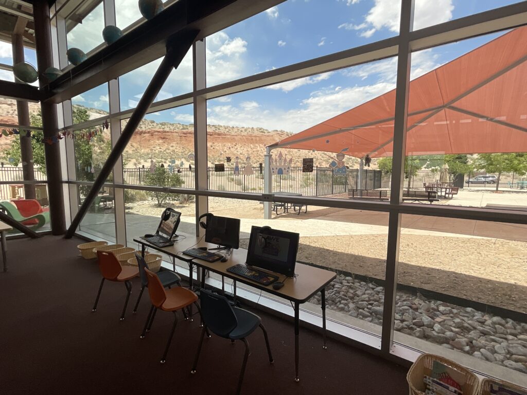 Computer stations in front of the large windows looking out to the patio in the children's area.