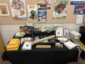 The contents of the Discovering Mesa Prieta trunk are organized on a table. To see the list of contents you may view the booking page for this item.