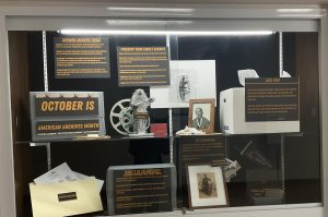 Display window with panels, photographs and artifacts.