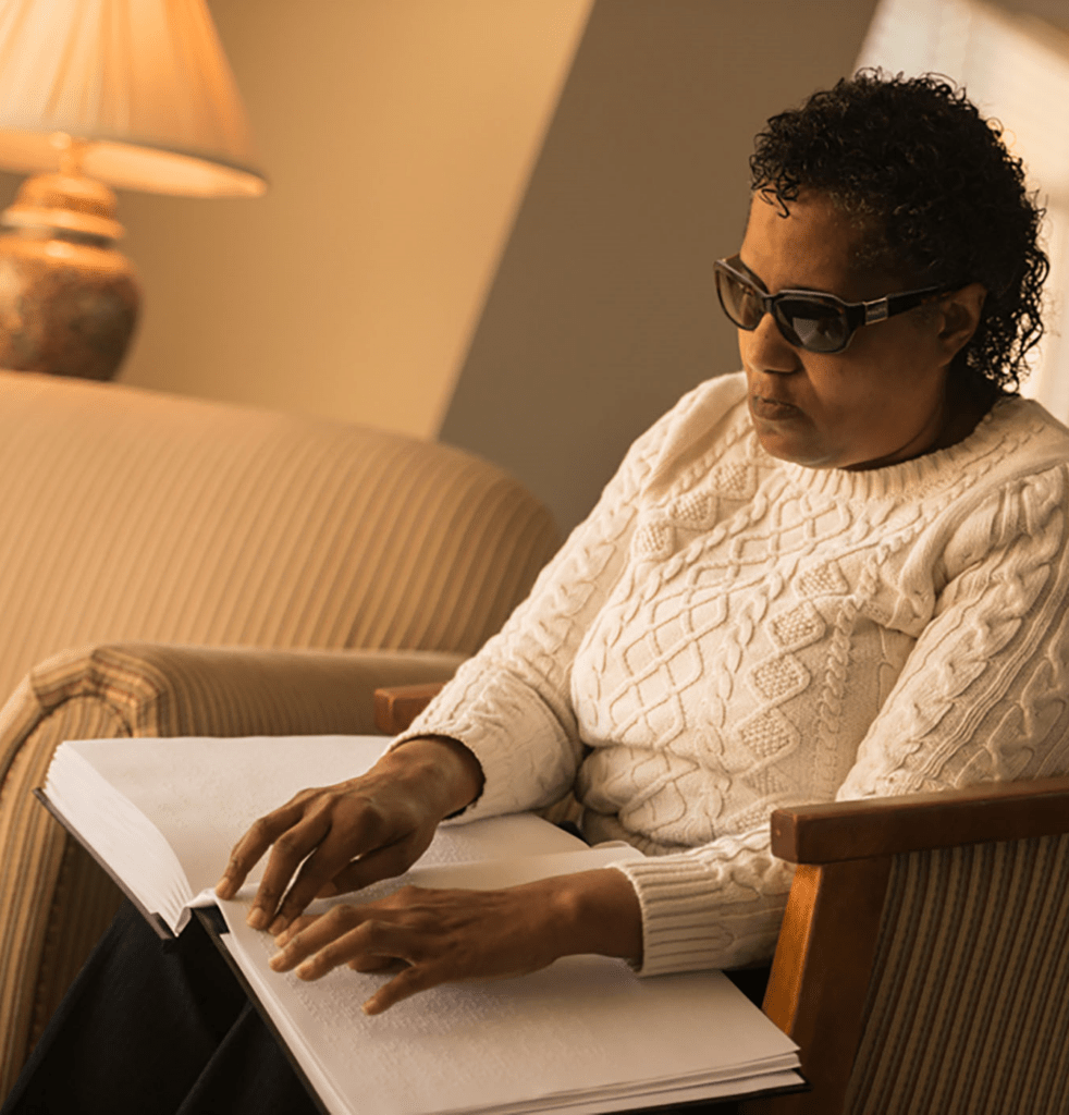 A woman reading a braille book