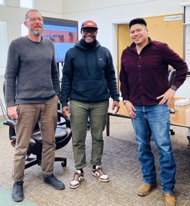 Three people standing inside the New Mexico State Library