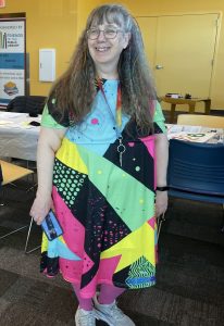 Woman wearing outfit with 1980s colors and patterns