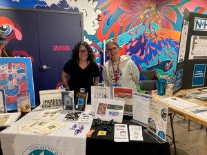 Librarians staffing NMSL table at Archival Oddities event.
